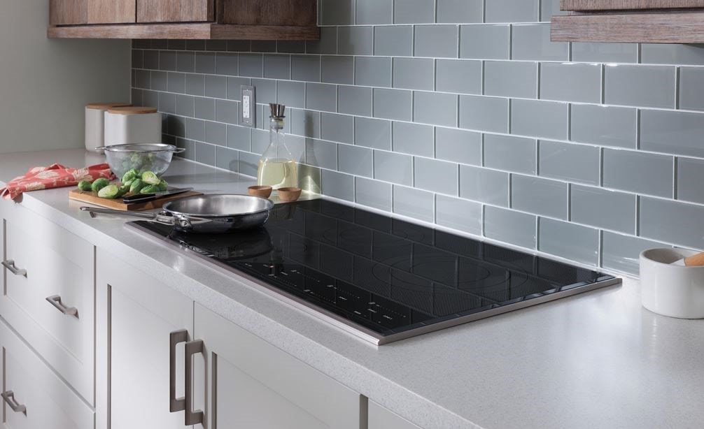 Wolf Induction Cooktop featured installed in a seamless flush white kitchen countertop.