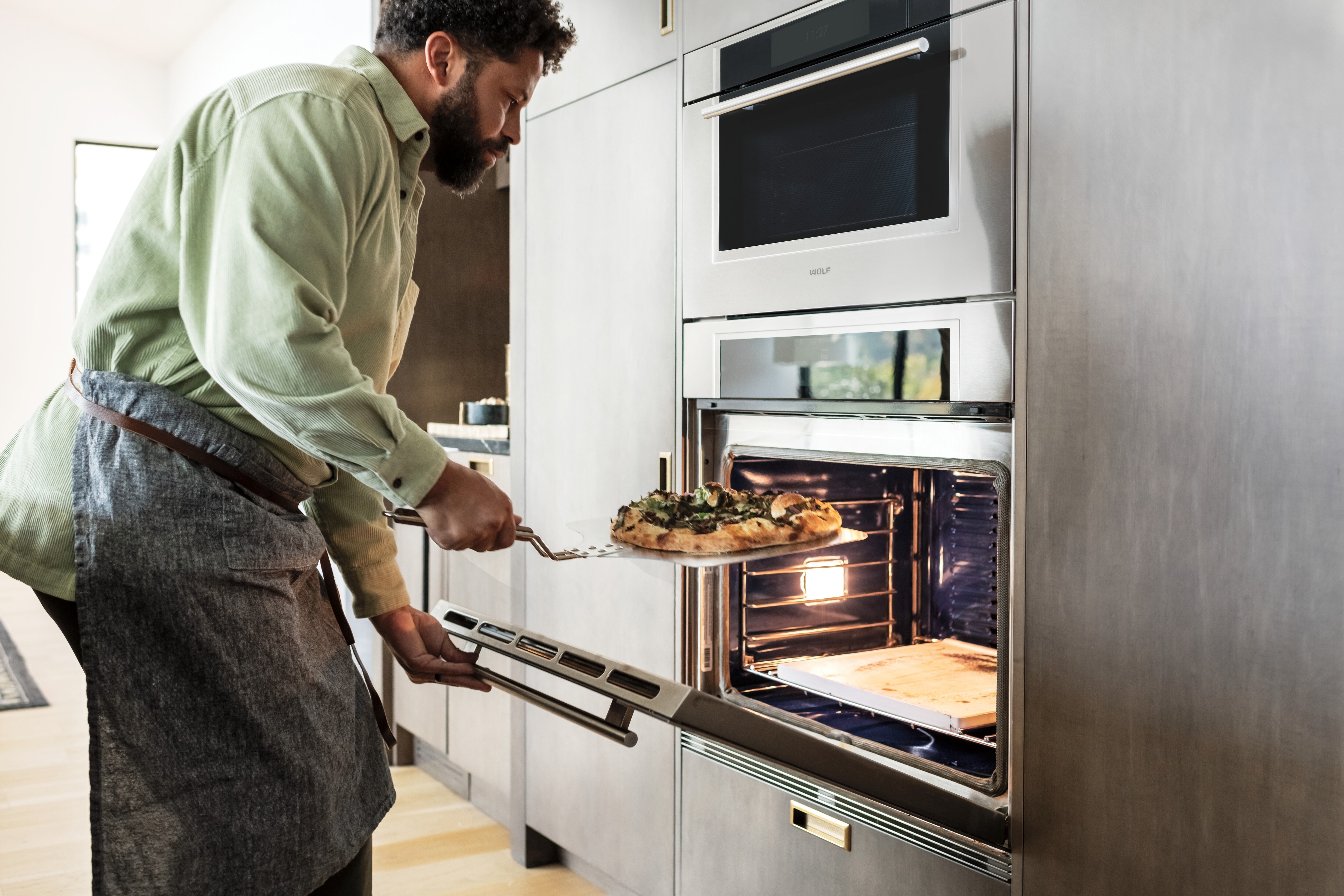 The Wolf 30 Inch M Series Transitional Convection Steam Oven and Transitional Single Oven shown flush in custom kitchen cabinetry