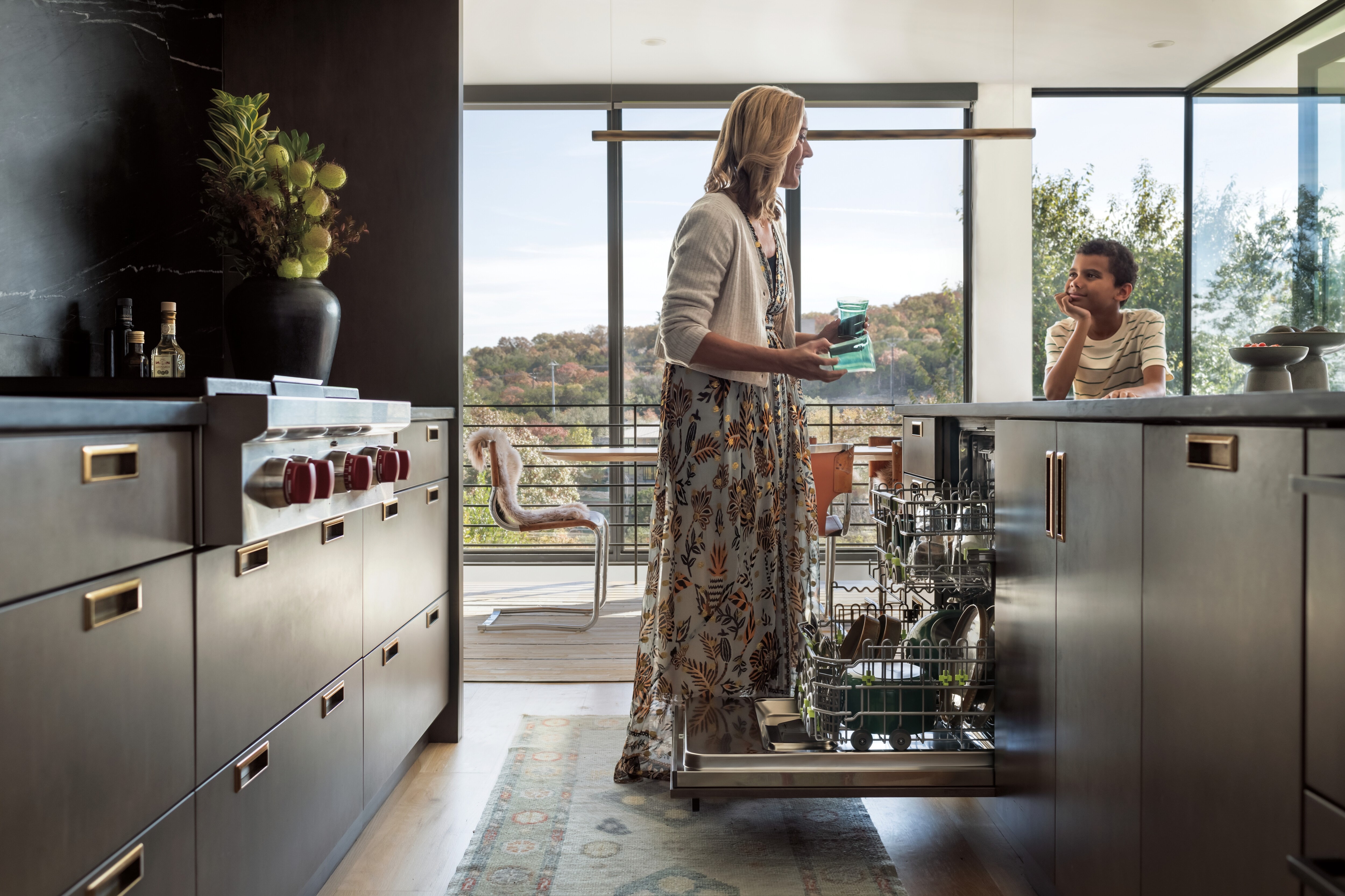 Built-in Panel Ready Cove Dishwasher shown with door open revealing perfectly clean dishes.